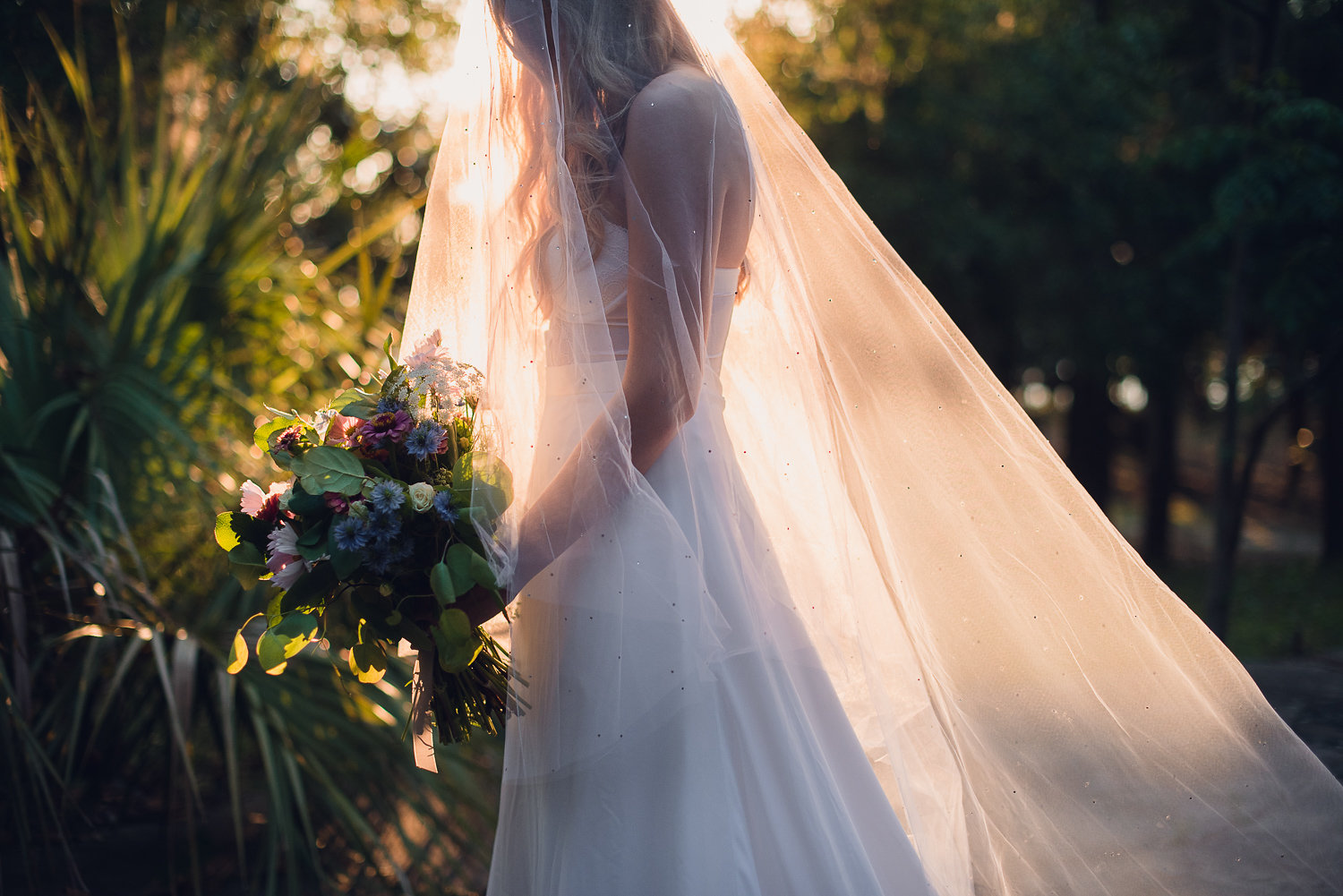 Elegant wedding ceremony arch decorated with soft, natural coastal florals